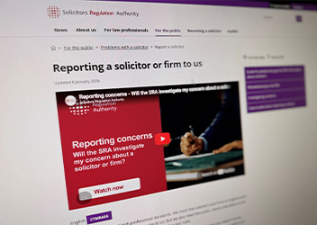 The image shows a webpage from the Solicitors Regulation Authority titled "Reporting a solicitor or firm to us." It includes a video thumbnail with the text "Reporting concerns - Will the SRA investigate my concern about a solicitor or firm?" There's a red play button on the video thumbnail. The page has sections for different audiences, like the public and law professionals, visible in the navigation menu.